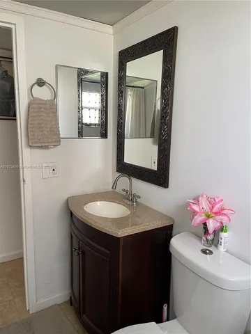 a bathroom with a sink vanity and mirror