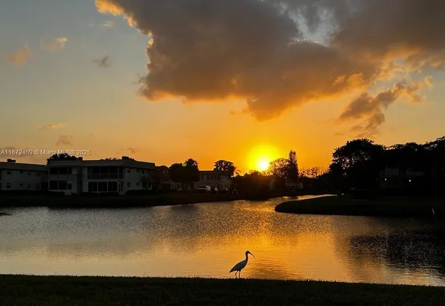 a view of lake with sunset