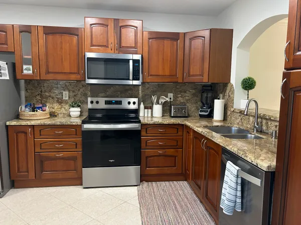 a kitchen with a sink stove and microwave