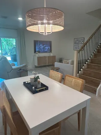 a kitchen with a table chairs and a chandelier