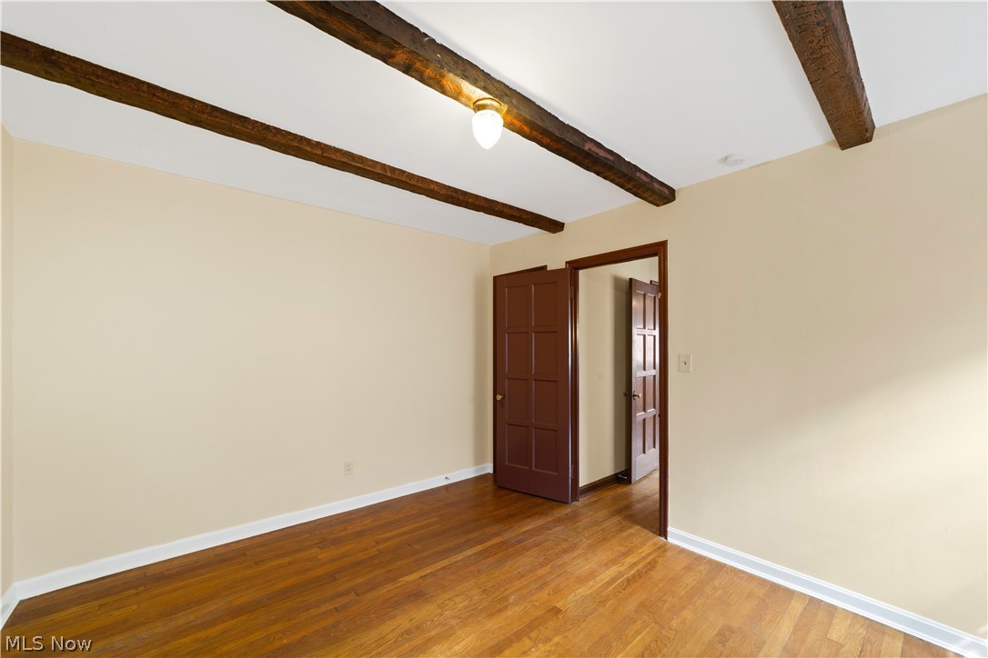 3666 Winchell Road Beachwood, OH 44122 - Photo 9 of 46 Spare room featuring light wood-type flooring and beamed ceiling