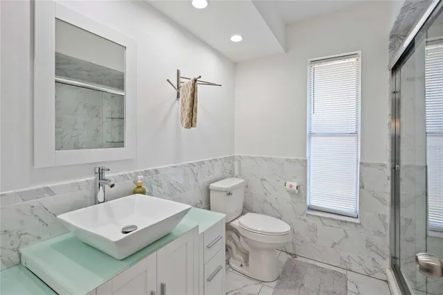 a bathroom with a toilet sink and a mirror