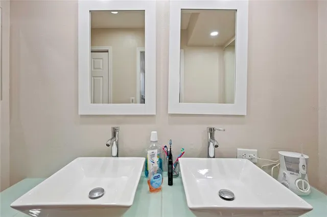 a bathroom with a tub a sink and mirror