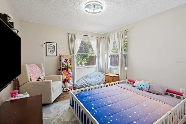 a bedroom with a bed and a couch