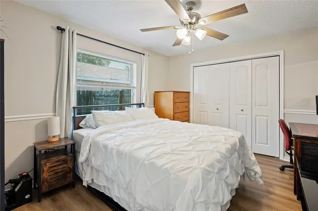 a bedroom with a large bed and a chandelier