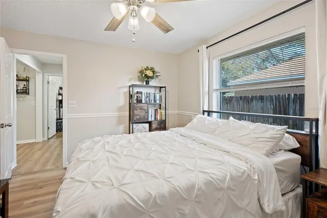 a bedroom with a bed and a large window