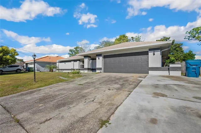 a view of a house with a backyard and a tree