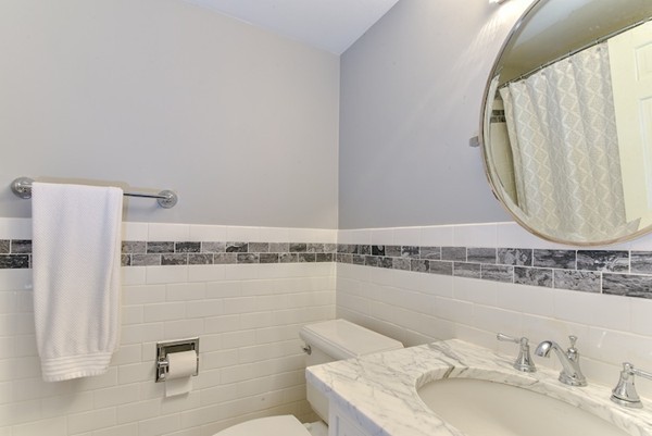 11 Alden Road Wellesley, MA 02481 - Photo 24 of 29 a bathroom with a granite countertop sink a mirror and shower