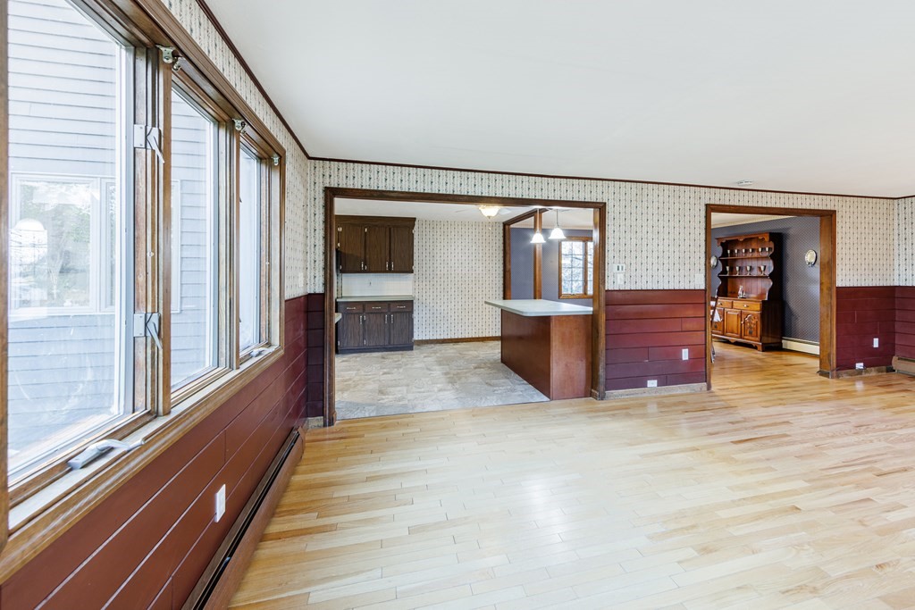 2 Lee Road Groveland, MA 01834 - Photo 16 of 41 a view of a hallway with wooden floor and furniture