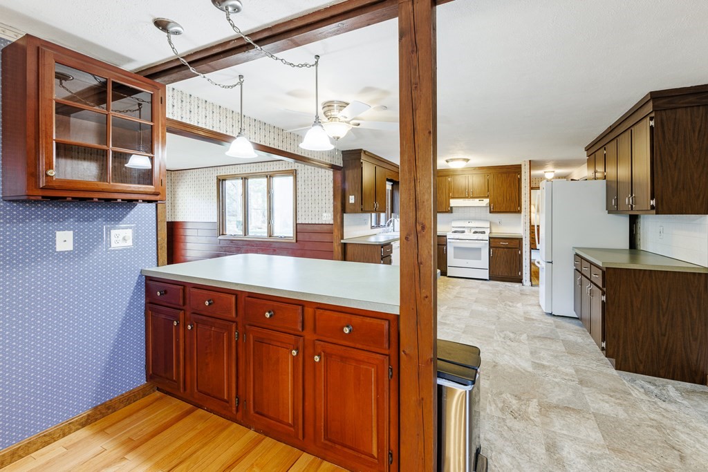 2 Lee Road Groveland, MA 01834 - Photo 21 of 41 a kitchen with stainless steel appliances granite countertop a sink and wooden cabinets