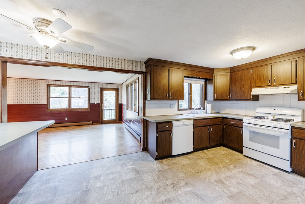 2 Lee Road Groveland, MA 01834 - Photo 22 of 41 a large kitchen with stainless steel appliances granite countertop a stove sink and cabinets
