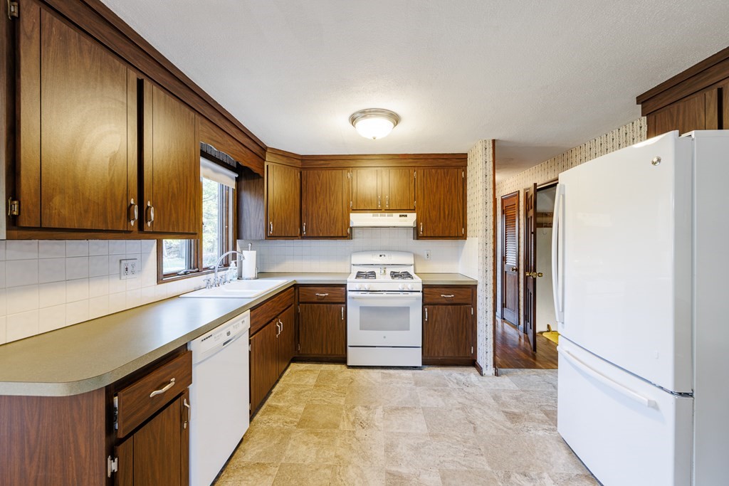 2 Lee Road Groveland, MA 01834 - Photo 23 of 41 a kitchen with stainless steel appliances granite countertop a refrigerator a sink and a stove