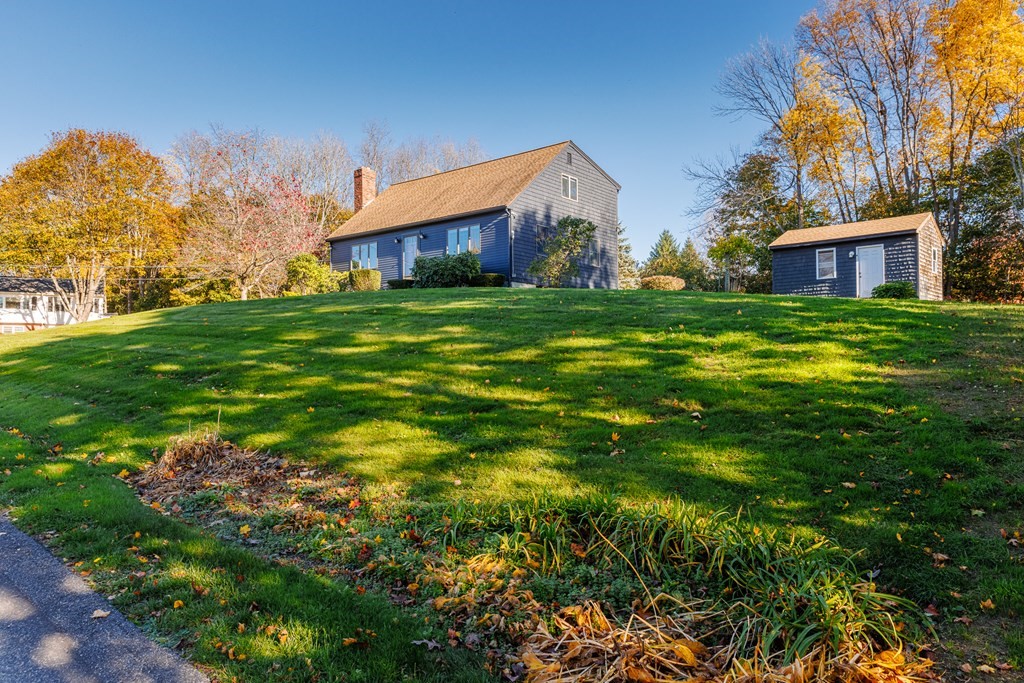 2 Lee Road Groveland, MA 01834 - Photo 4 of 41 a front view of house with yard and trees in the background