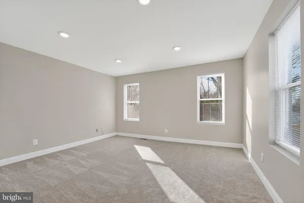 a view of wooden floor and windows in a room