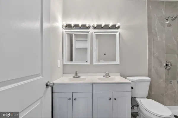 a bathroom with a sink toilet and mirror