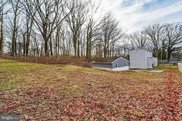 a backyard of house with a slide and large trees