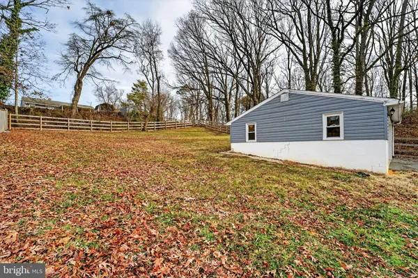 a backyard of a house with large trees