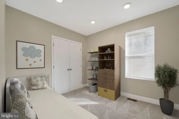 a bedroom with a bed and a potted plant