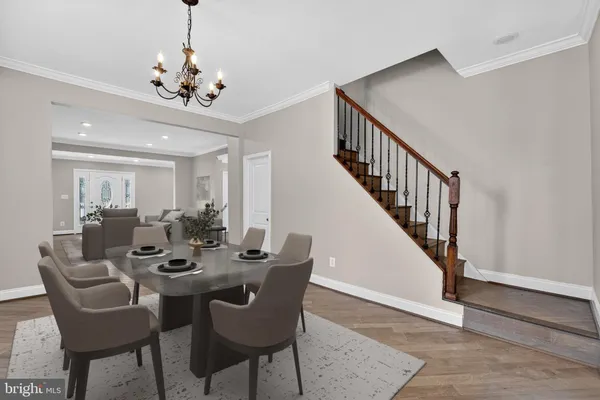 a view of a dining room with furniture wooden floor and chandelier