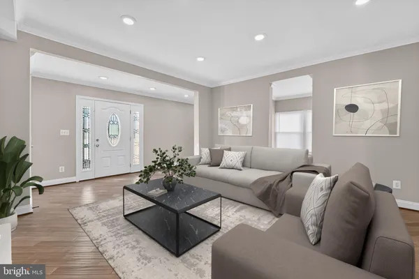 a living room with furniture potted plant and a window