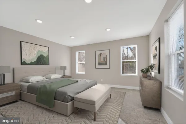 a bedroom with a large bed couch and a window
