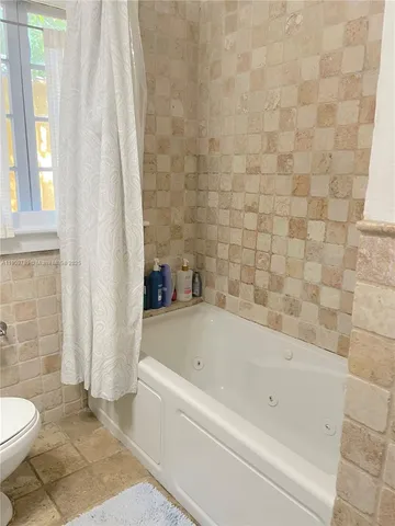 a bathroom with a bathtub and a toilet