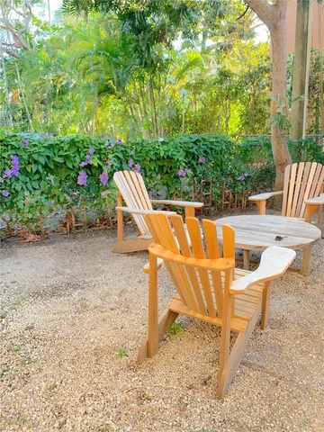 a view of a chairs and table in backyard