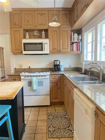 a kitchen with stainless steel appliances granite countertop a sink and cabinets