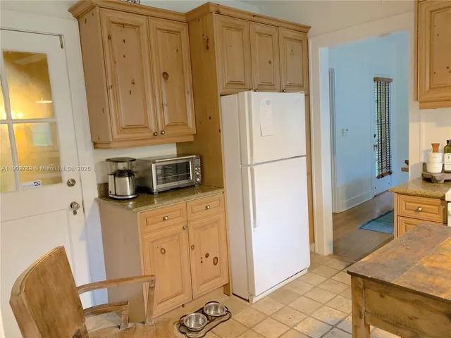 a kitchen with stainless steel appliances a refrigerator sink and cabinets