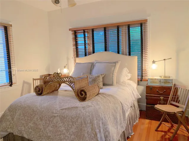 a large bed sitting in a bedroom next to a window