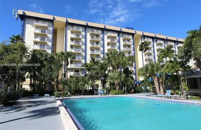 a front view of a building with a garden
