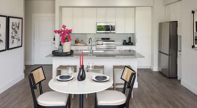 a dining room with furniture and wooden floor