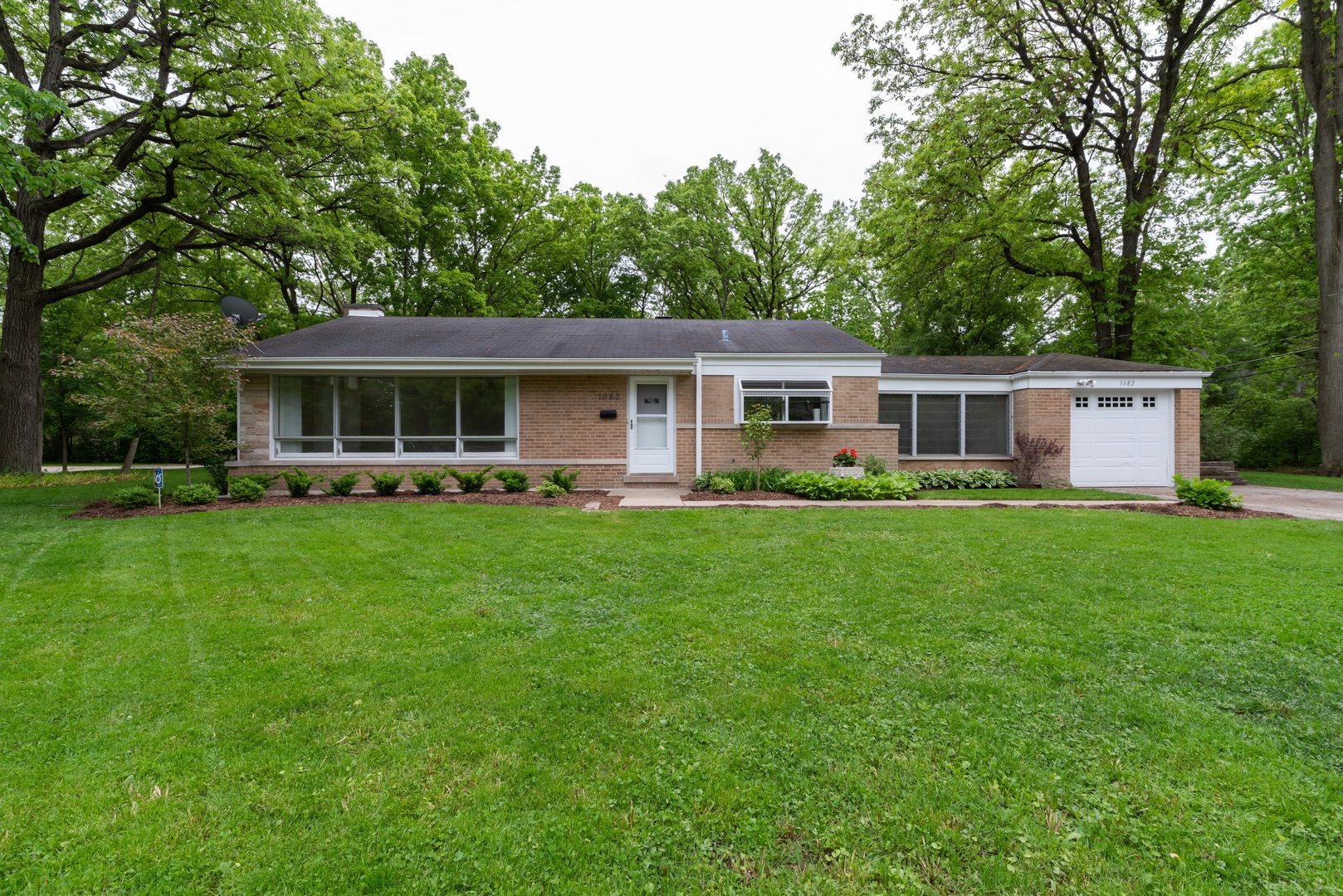 1682 Berkeley Road Highland Park, IL 60035 - Photo 1 of 15 a front view of house with yard and green space