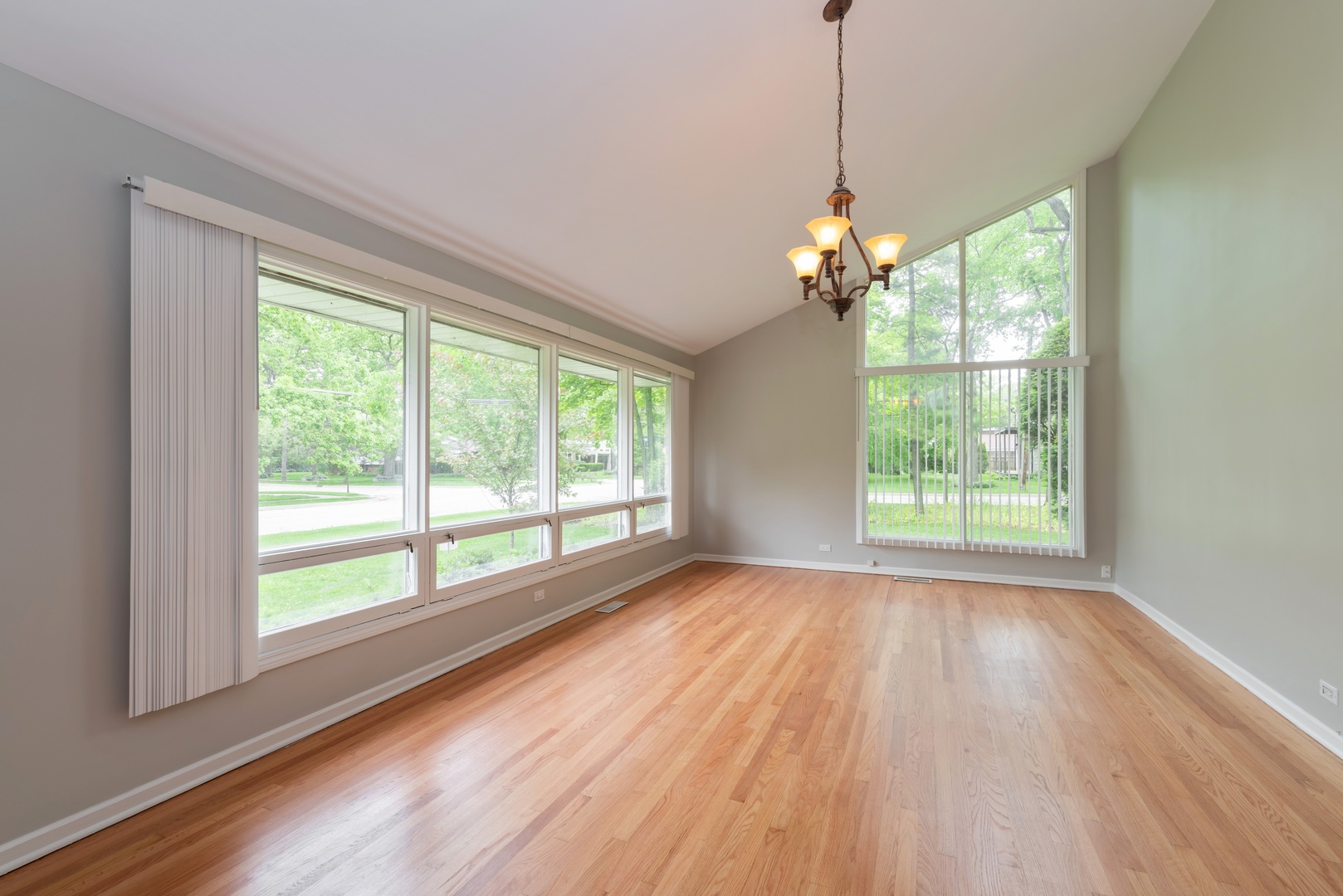1682 Berkeley Road Highland Park, IL 60035 - Photo 2 of 15 a view of a room with wooden floor chandeliers and kitchen view