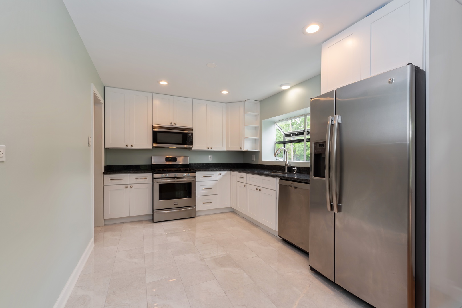 1682 Berkeley Road Highland Park, IL 60035 - Photo 4 of 15 a kitchen with stainless steel appliances granite countertop a refrigerator sink and stove