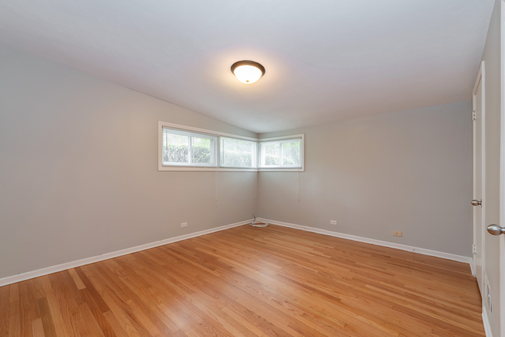 1682 Berkeley Road Highland Park, IL 60035 - Photo 7 of 15 an empty room with wooden floor and windows