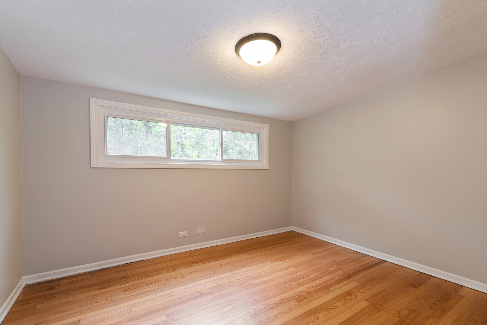 1682 Berkeley Road Highland Park, IL 60035 - Photo 8 of 15 an empty room with wooden floor and windows
