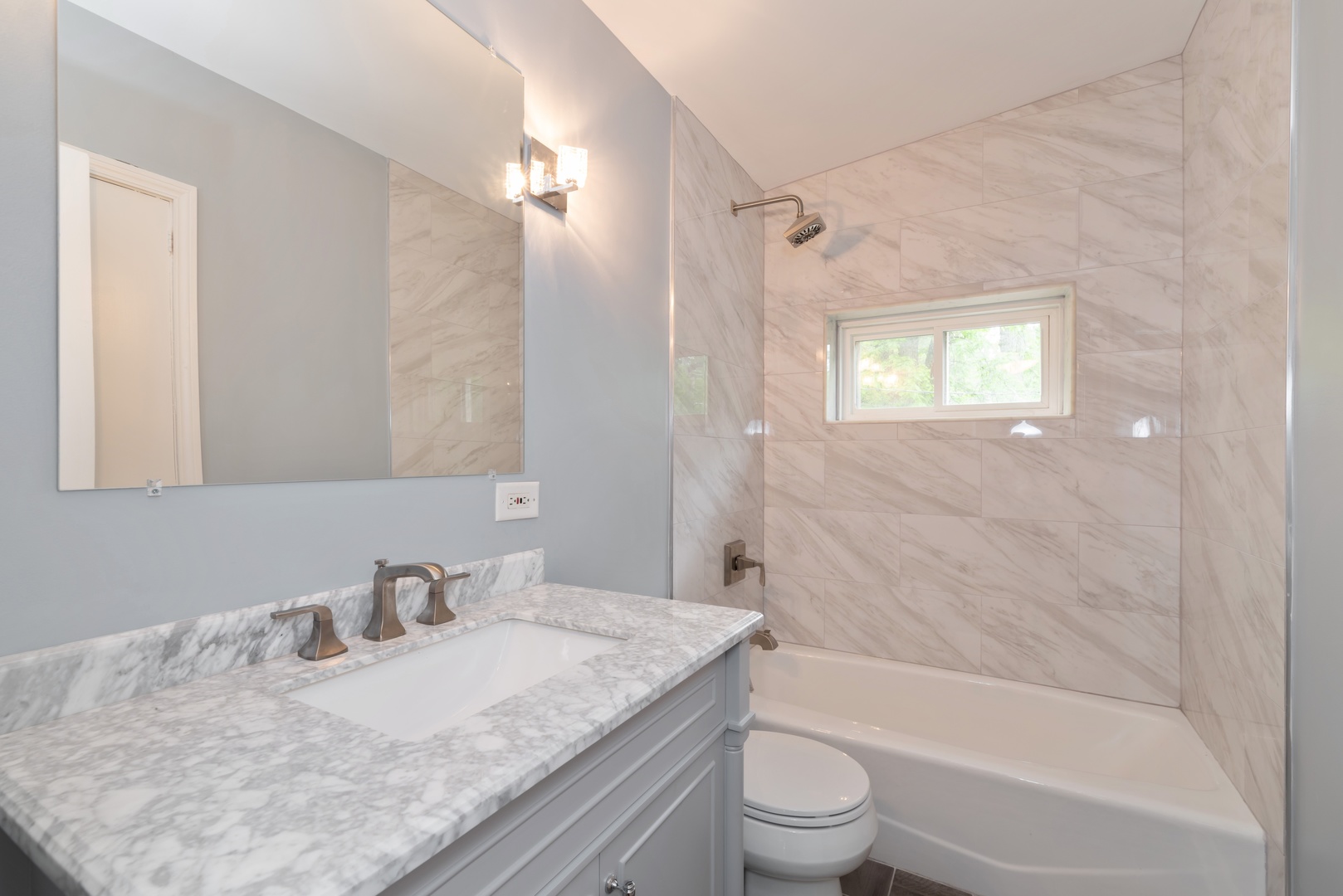 1682 Berkeley Road Highland Park, IL 60035 - Photo 9 of 15 a bathroom with a granite countertop sink toilet and shower