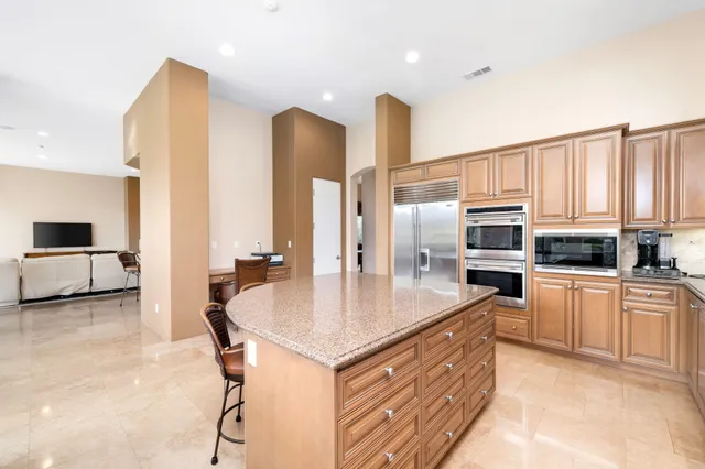 a kitchen with stainless steel appliances a sink stove and refrigerator