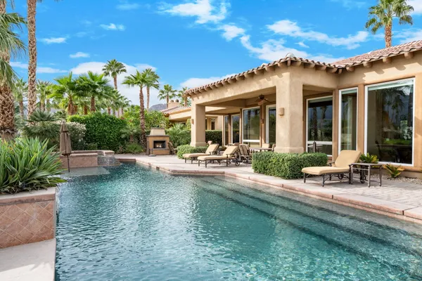 a view of a patio with swimming pool table and chairs