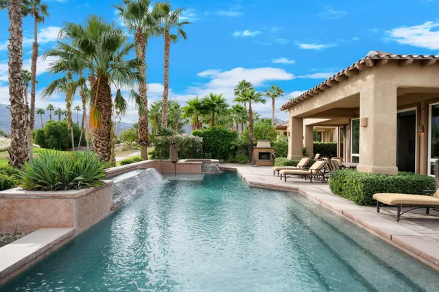 a swimming pool with outdoor seating and yard