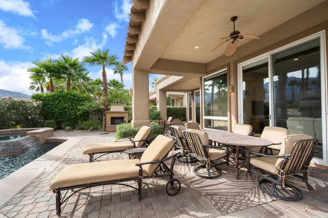 a view of swimming pool with outdoor seating and plants