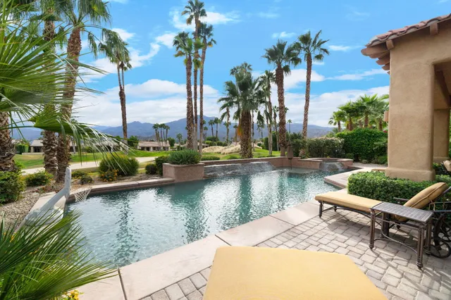 a view of a backyard with plants and a patio