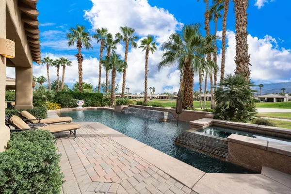 a view of a backyard with plants and a patio