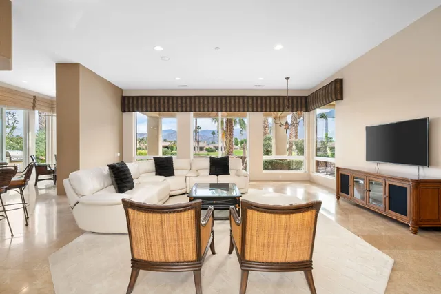 a living room with fireplace furniture and a flat screen tv