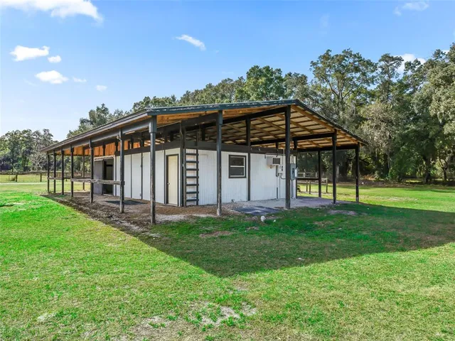 a view of a porch with furniture and a backyard