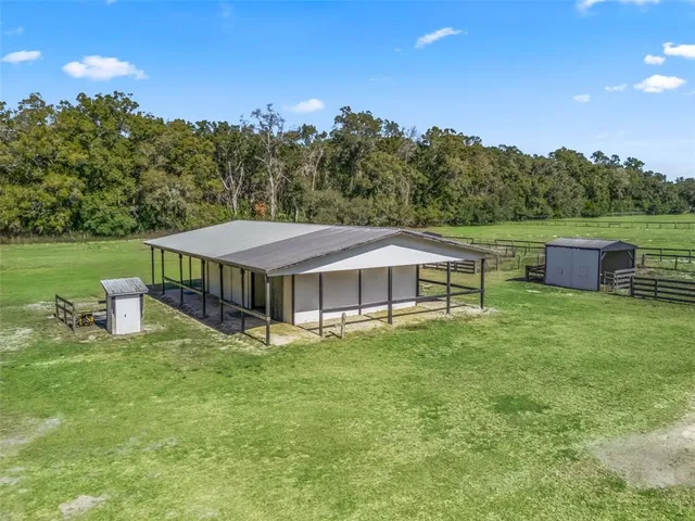 a view of a house with a yard balcony and sitting area