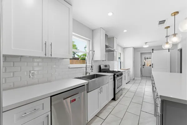 a kitchen with a sink and cabinets