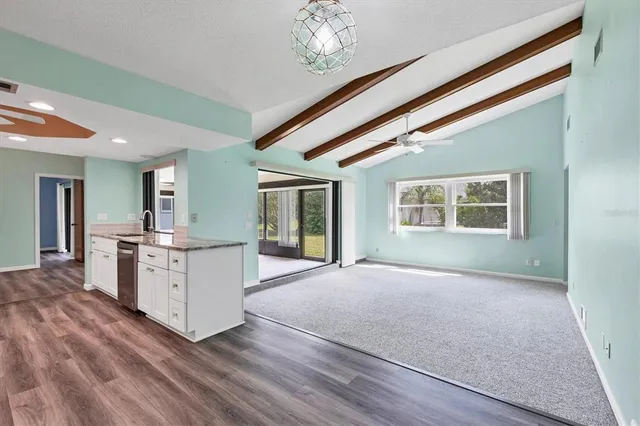 a open kitchen with stove and white cabinets