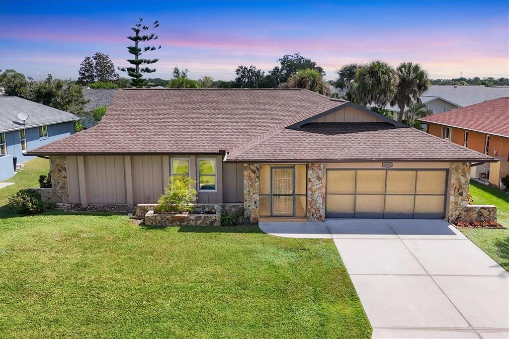 5833 Harrison Road Venice, FL 34293 - Photo 2 of 51 a front view of a house with a garden and yard